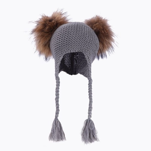 Grey knit baby trapper hat with two brown fur pom-poms and braided earflaps