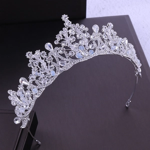 Detailed close-up of bridal crown featuring clear crystals and milky opals on silver band
