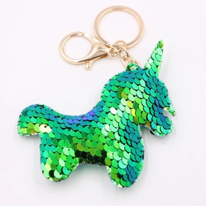 Sparkling green sequin unicorn keychain with golden metal ring on white background