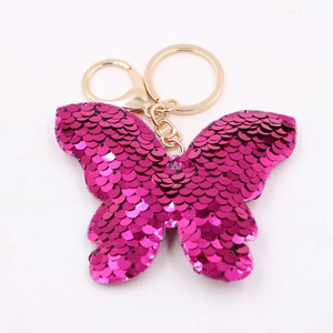 Close-up of rose red sequin butterfly keychain with gold circular ring and chain