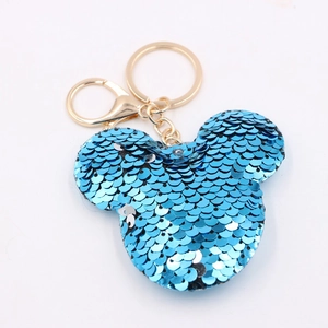 Detail of blue sequined Mickey-shaped keychain with gold metal hardware and lobster clasp