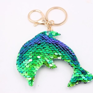 Detailed close-up of mermaid tail sequin keychain with shiny blue gradient and gold clasp