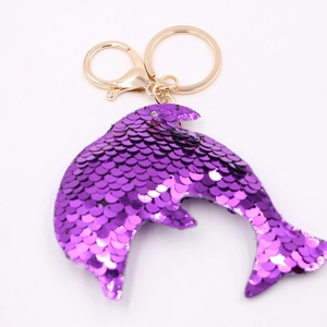 Cute purple sequin dolphin keychain with gold metal lobster clasp on white background