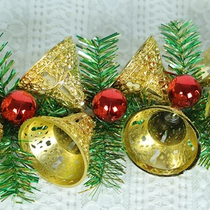 Christmas hanging ornament with gold bells red baubles and green tinsel garland
