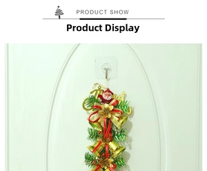 Detail of Christmas door hanger with gold bells, red bow, pine needles and snowman