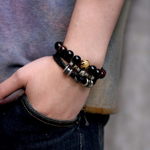 Men's leather zodiac bracelet set with black beads and skull details on wrist