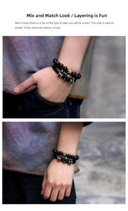 Detail of layered men's braided leather bracelet with eagle motif beads and tiger eye stones