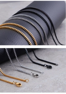 Detail of square box chains in gold, silver, and black finish with lobster clasps