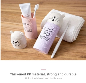 Close-up of portable travel toothbrush cases in pink and purple with cute bear design