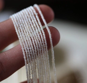 Macro shot of 4mm natural freshwater tiny pearls strands for handmade jewelry making