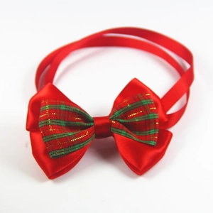 Close-up of red and green plaid pet bow tie with double layer satin and gold bell