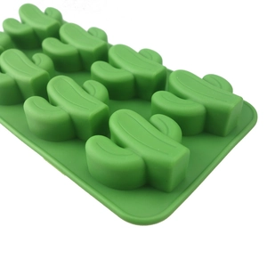 Detail showing green silicone mold with cactus shaped cavities for ice and chocolate