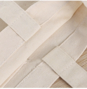 Close-up of canvas tote bag showing reinforced double stitching and weave texture