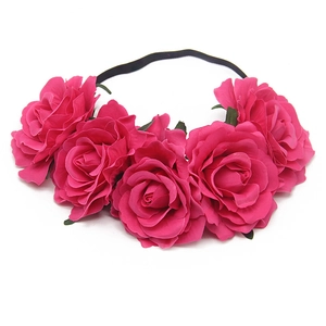 Detail of lifelike pink fabric roses on a black elastic headband for festive parties