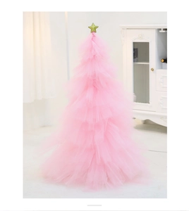 Close-up of a pink tulle DIY mini Christmas tree with a sparkling gold star topper