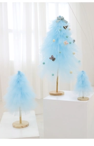 Detailed view of light blue tulle mini Christmas trees with pink bunny and ribbon decor