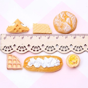 Miniature resin waffles and pastries shown with a ruler to demonstrate small scale