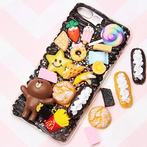 DIY phone case featuring colorful miniature resin food charms and cartoon bear characters