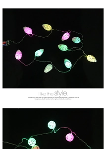 Macro detail of colorful egg-shaped LED Christmas string lights with battery box