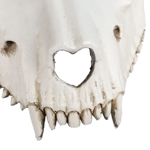 Detail shot of 3D sheep skull mask featuring heart-shaped nose and sharp realistic teeth