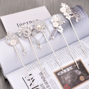Detailed close-up of five silver Chinese hair pins with pearls and butterfly tassels