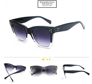 Detail view of cat-eye sunglasses featuring black gradient frames and golden dot accents