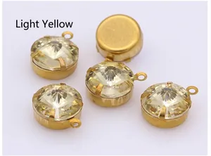 Macro detail of light yellow round crystal gems with gold metal loop claw settings
