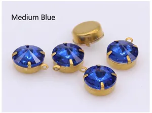 Detailed macro view of medium blue faceted crystal pendants with gold metal bases