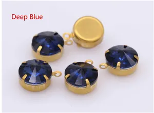 Macro shot of dark blue faceted crystal pendants with gold claw settings for DIY jewelry