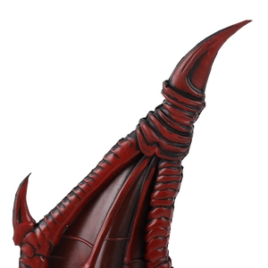Detailed close-up of red and black textured dragon scales on a kids cosplay wing prop