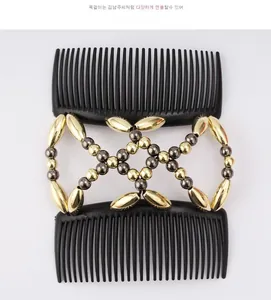 Detail of magic hair comb with dual black plastic clips and elastic metallic beaded strings
