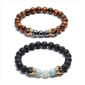 Detail of lava rock and tiger eye stone bracelets with micro-inlaid zircon gold crowns