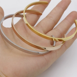 Polished stainless steel C-shaped cuff bangle set in gold, silver, and rose gold finishes