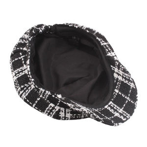 Inside view of black and white plaid newsboy cap with cotton lining and size tag