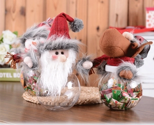 Detailed view of Santa and Reindeer plush toppers on clear Christmas candy jars