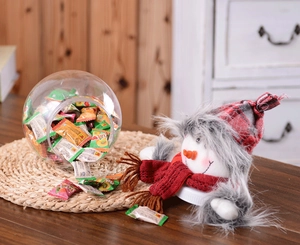 Close-up of a snowman candy jar with a plaid hat and transparent round storage bottle