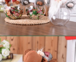 Detail of Christmas candy jars featuring plush gnome and reindeer ornaments on top