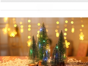 Close-up of mini sisal Christmas trees with LED lights and solid wooden bases