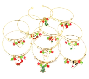 Detail of gold Christmas charm bracelets with Santa Claus and reindeer pendants