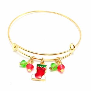 Detailed view of golden Christmas bangle with red stocking charm and colorful glass beads