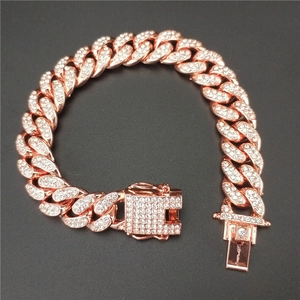 Detail of 12mm rose gold Cuban link bracelet with iced-out cubic zirconia pavé stones