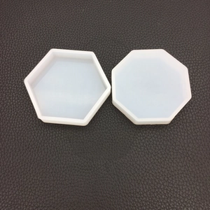 Top view of hexagonal and octagonal silicone molds for DIY resin crafts on black leather