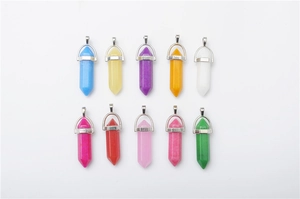 Detailed top view of ten assorted colorful quartz crystal point pendants in two neat rows