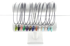 Selection of hexagonal quartz point pendants in various colors on a T-bar display stand
