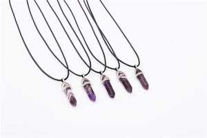 Detail view of five hexagonal amethyst quartz point pendants with black cord necklace straps