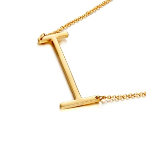Polished gold-plated 3D capital letter I pendant on a delicate chain in top-down view