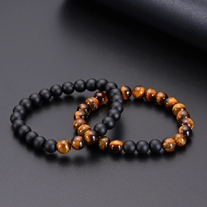 Detail of 8mm tiger eye and matte black stone beaded friendship bracelets for couples