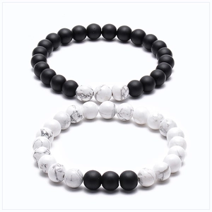 Detail of 8mm tiger eye and matte stone friendship bracelets for couples on white background