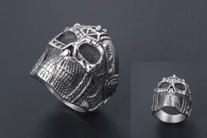 Detailed view of silver stainless steel skull ring with intricate punk carvings