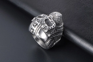 Macro detail of silver stainless steel punk ring featuring complex mechanical relief